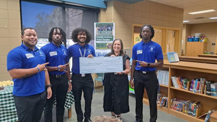 pi-rho-chapter-makes-monetary-donation-to-adopted-school.jpg
